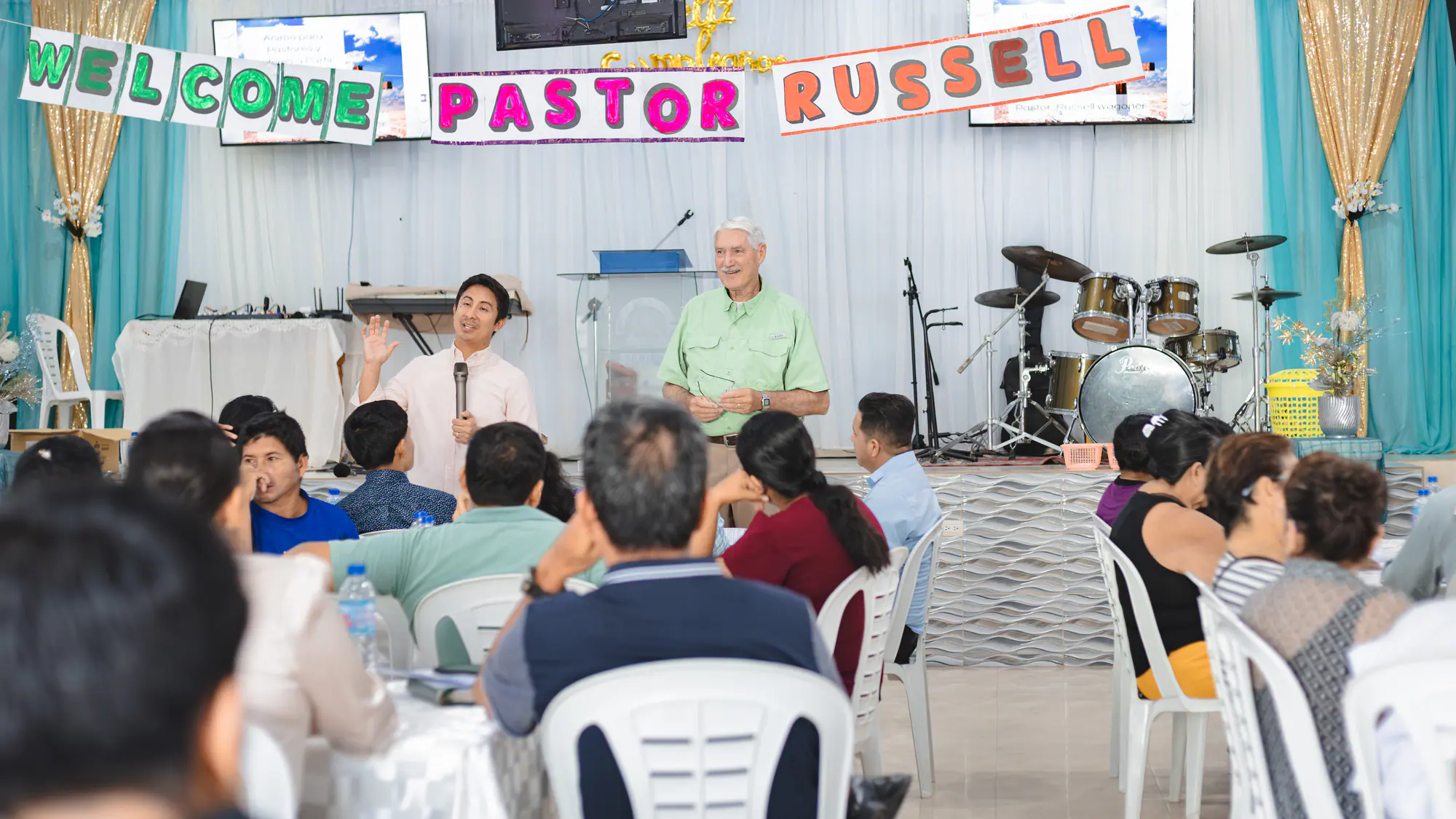 A full pastoral training gathering with Russell and Israel at the front of the room.