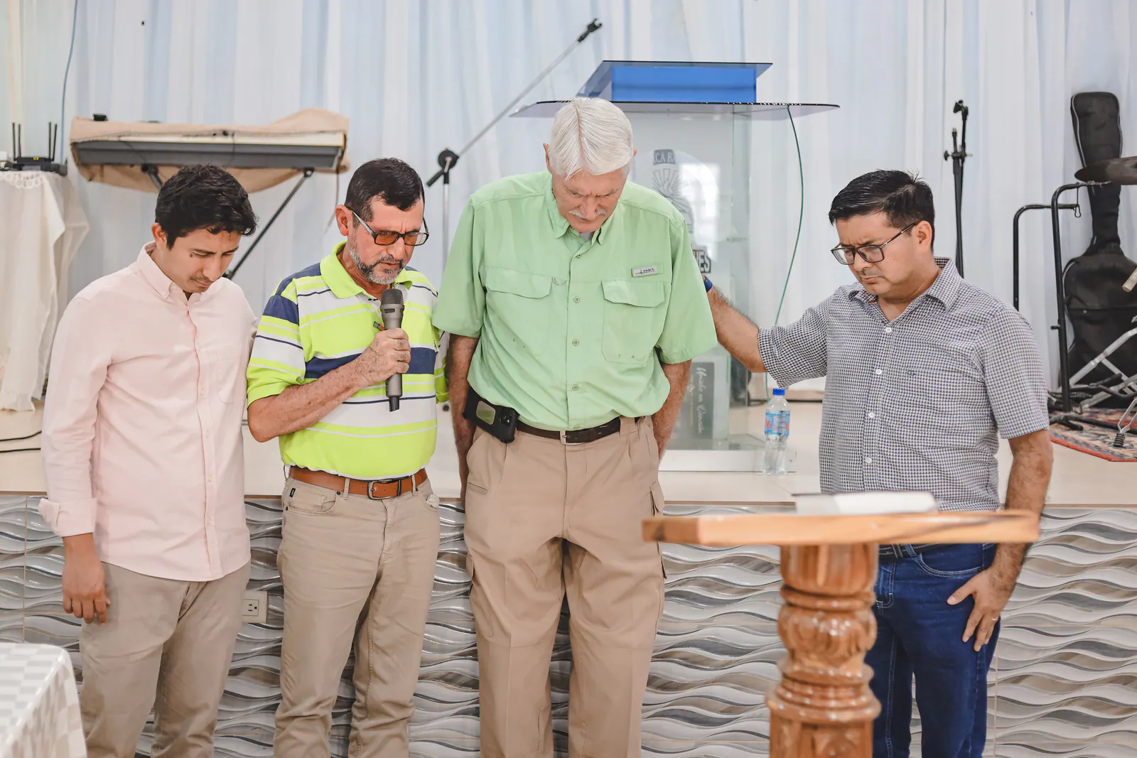 Pastors placing hands on a fellow pastor during a time of prayer and encouragement.