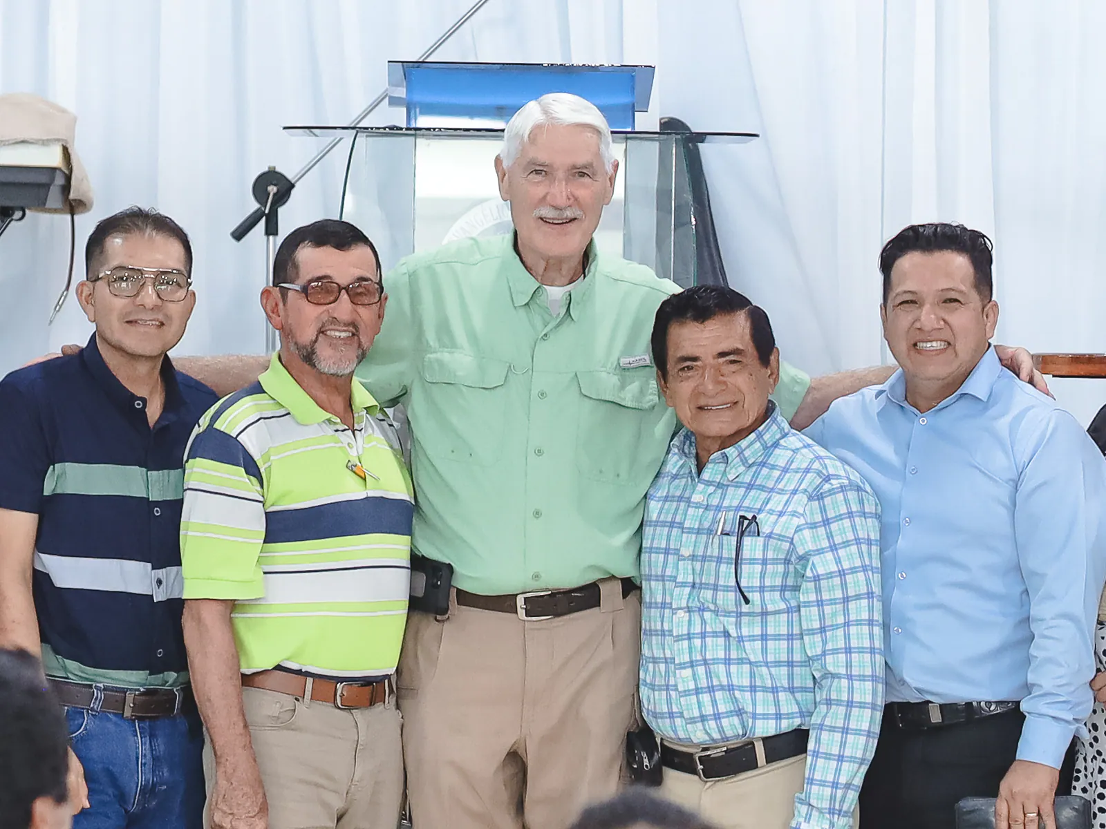 Russell surrounded by pastors after a training gathering in Ecuador.
